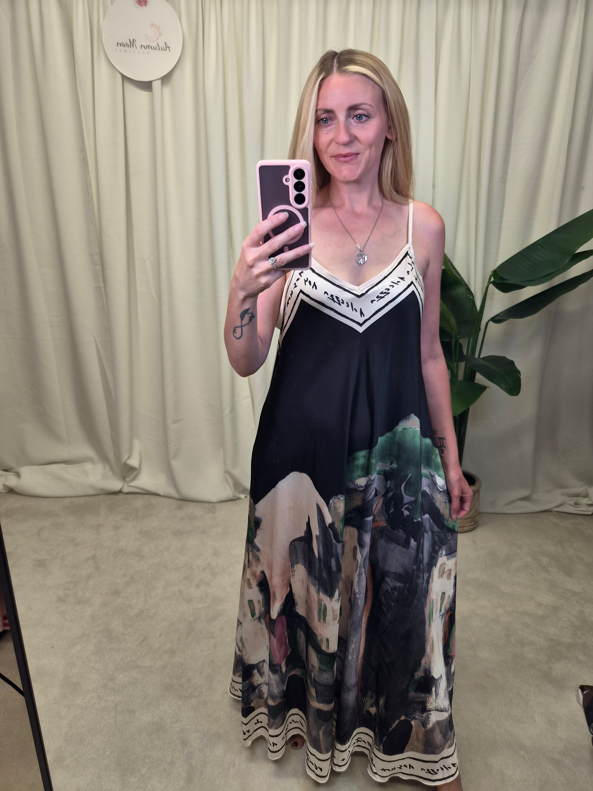 Vespera Landscape Print Slip Maxi Dress — black spaghetti strap maxi dress with landscape scene print at hem and script border trim