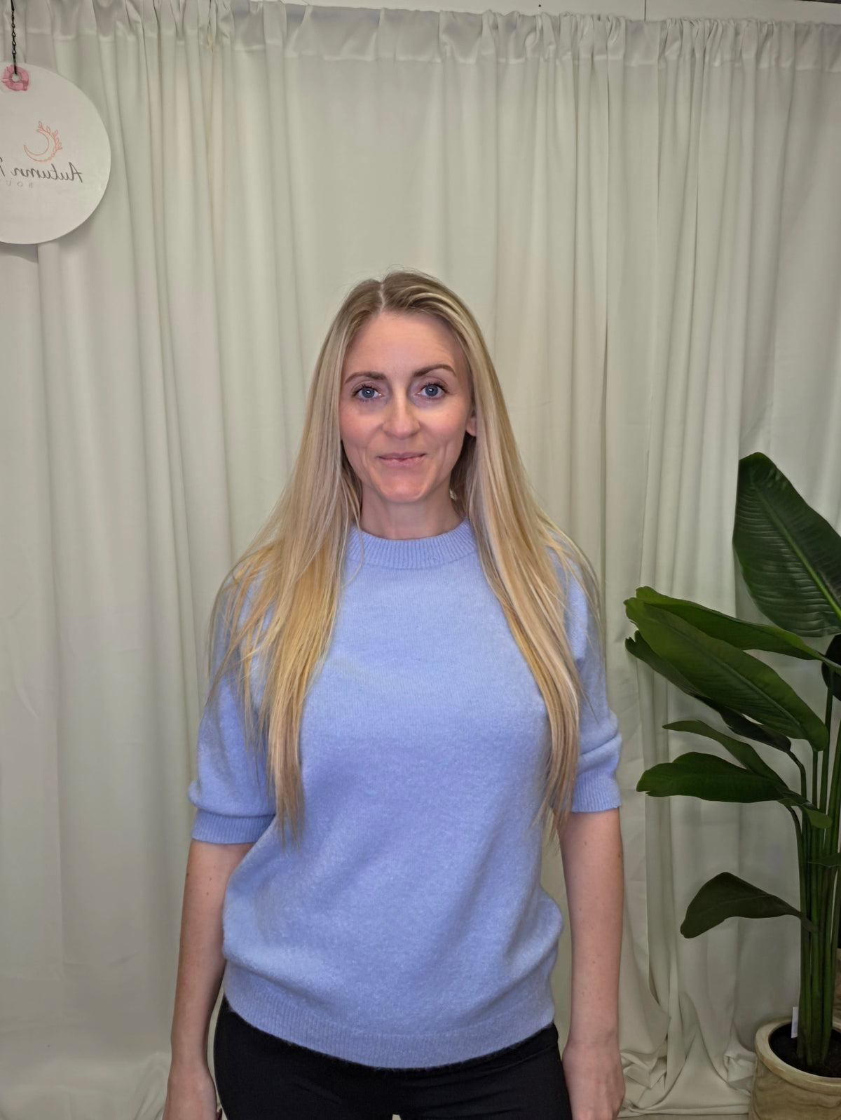 Scorpio light blue knit jumper modelled with black trousers